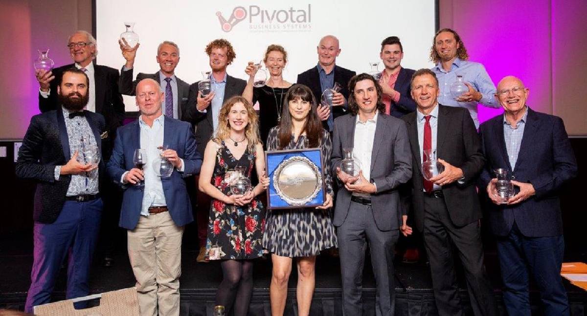 Group photo of people holding wine awards